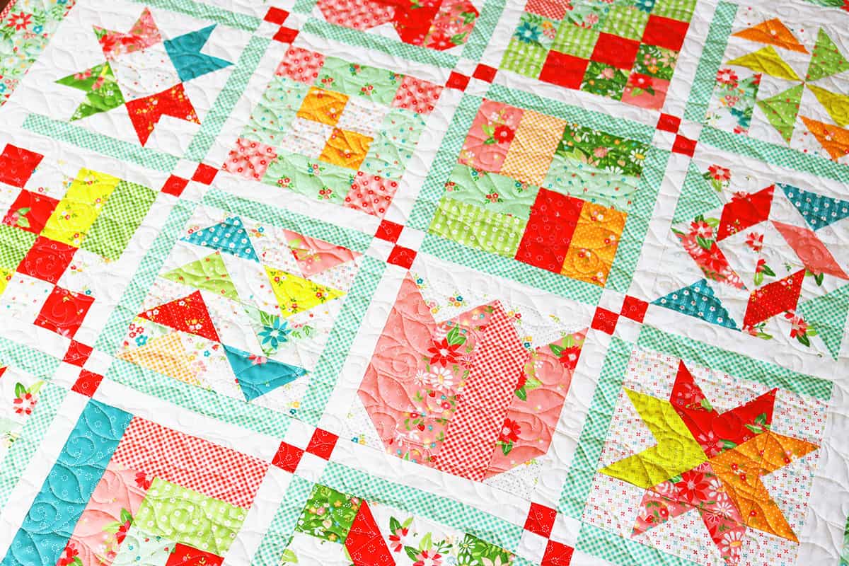 Jelly Roll Sampler Quilt in Strawberry Lemonade fabrics by Sherri from A Quilting Life