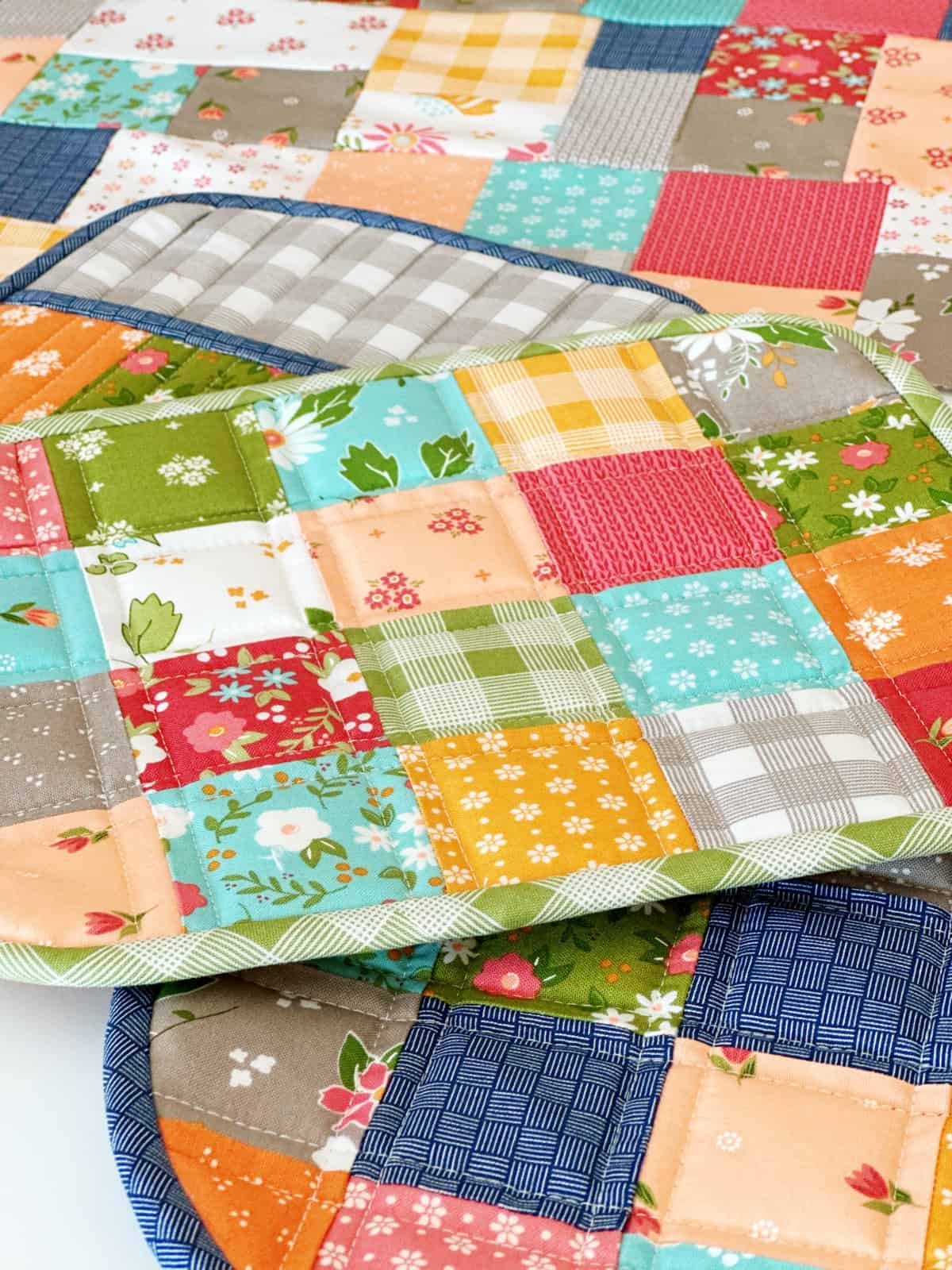 patchwork quilted potholders in bright fall colors
