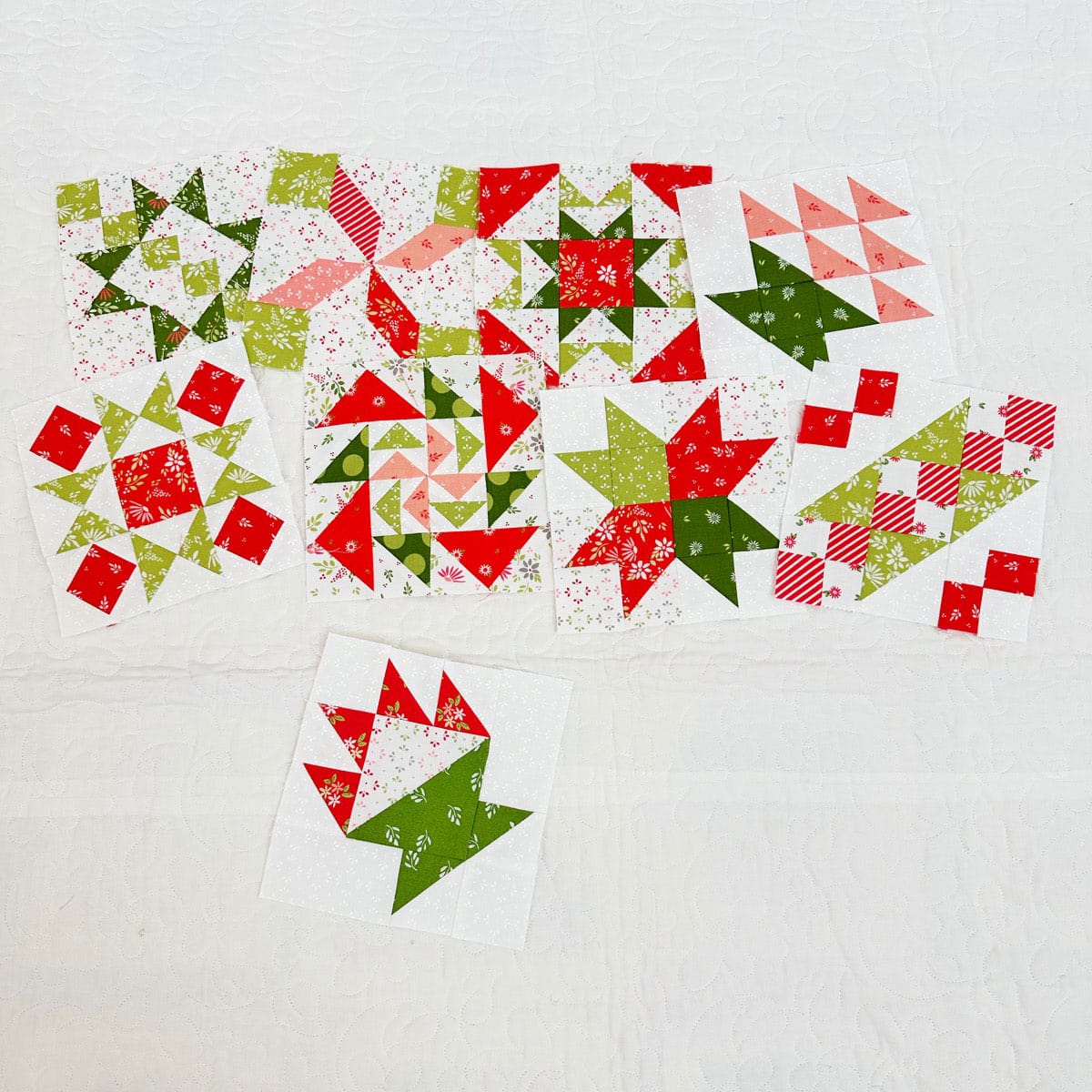 Christmas fabric quilt blocks in a variety of designs.