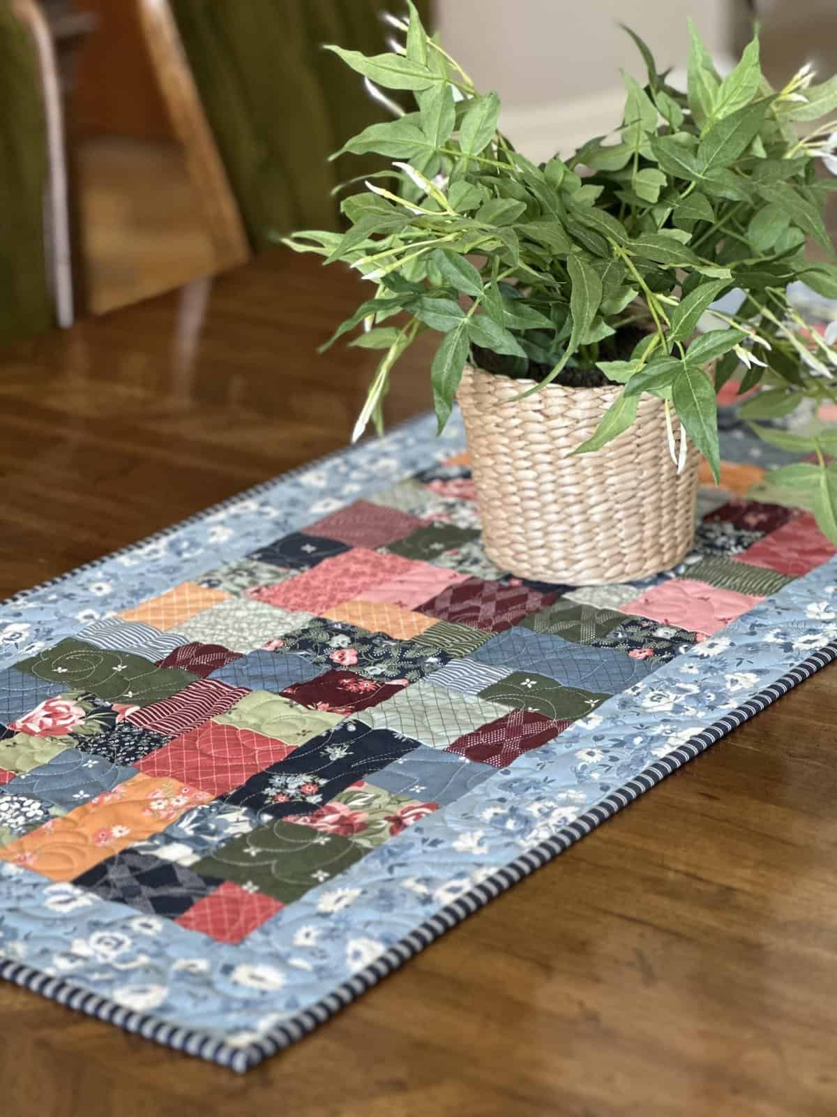 quilted table runner and greenery on a table