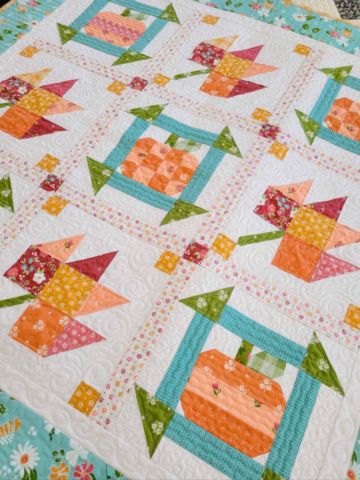 Fall patchwork quilt with pumpkins and leaves