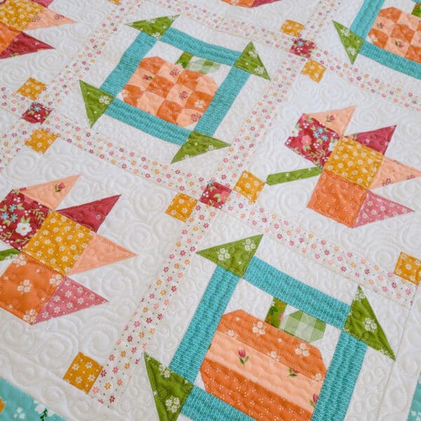 Patchwork Fall Quilt with pumpkins and leaves in bright fall colors