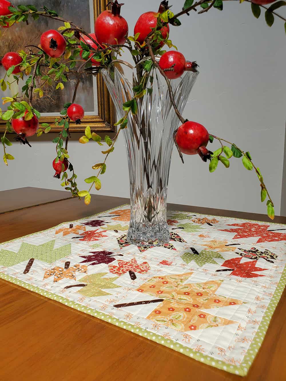 pomegranate leaves and stems on patchwork leaf table topper 