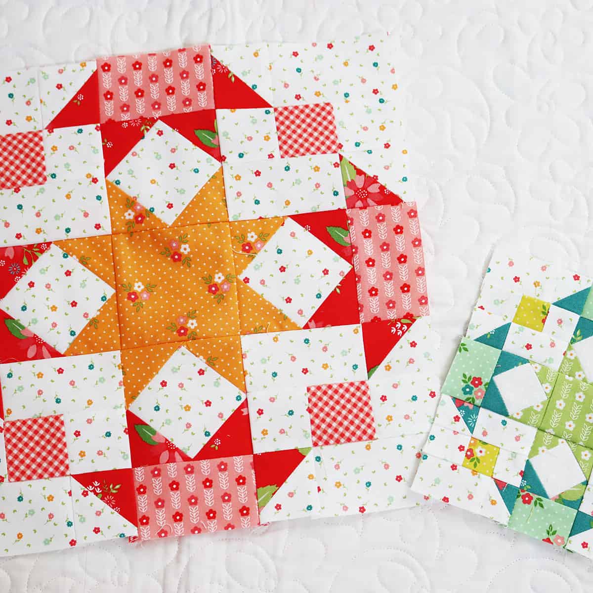 Large and small star design patchwork blocks in bright colors with a center star surrounded by four half star designs.