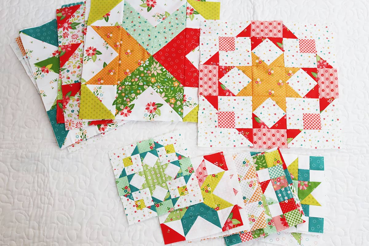 A variety of brightly colored patchwork quilt blocks in different colors and sizes.