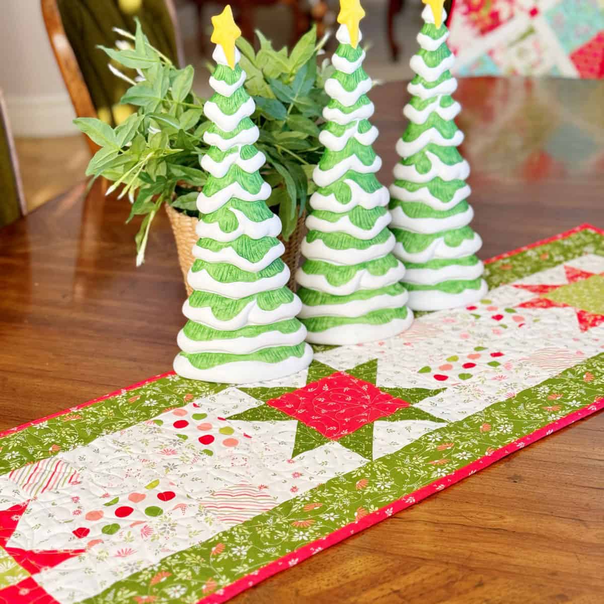 Christmas Star Table runner with ceramic Christmas trees and a plan on table