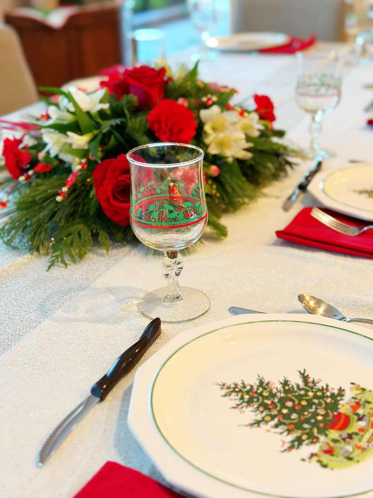 Christmas plate and goblet with Christmas floral arrangement