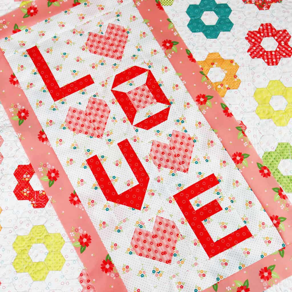 Love wall hanging in pink and red fabrics