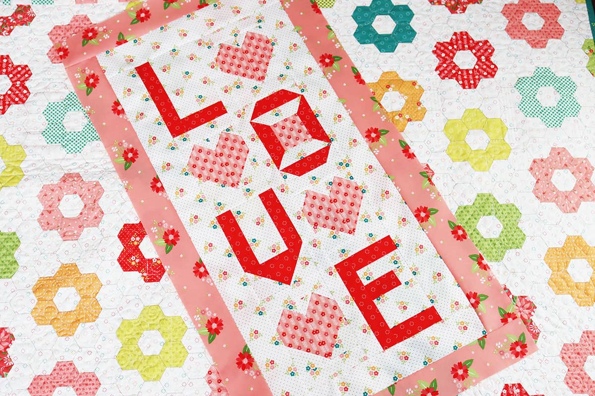 Love wall hanging in pink and red fabrics