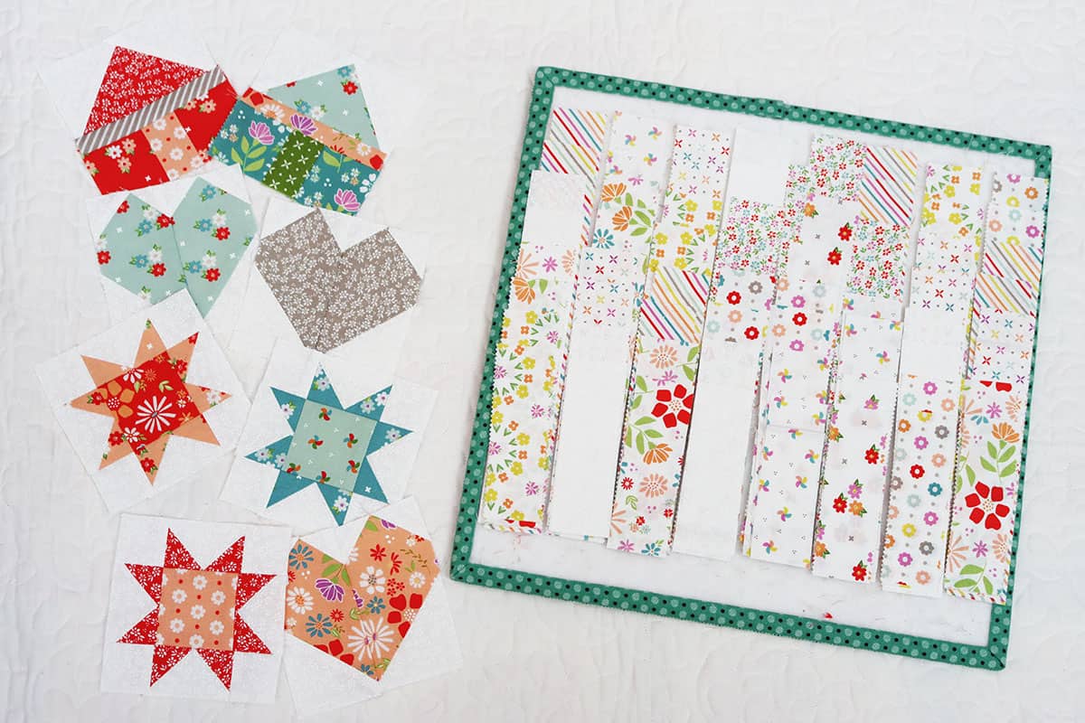House, star, and heart quilt blocks in bright fabrics with light fabric strips.