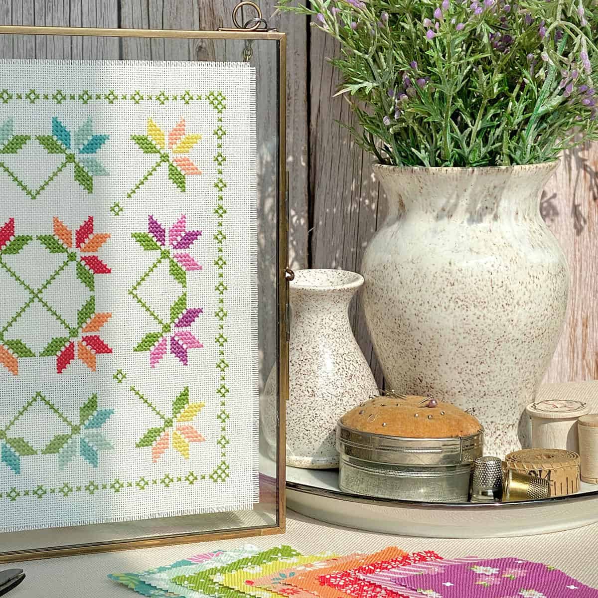 Cross Stitch patchwork in frame in bright spring colors