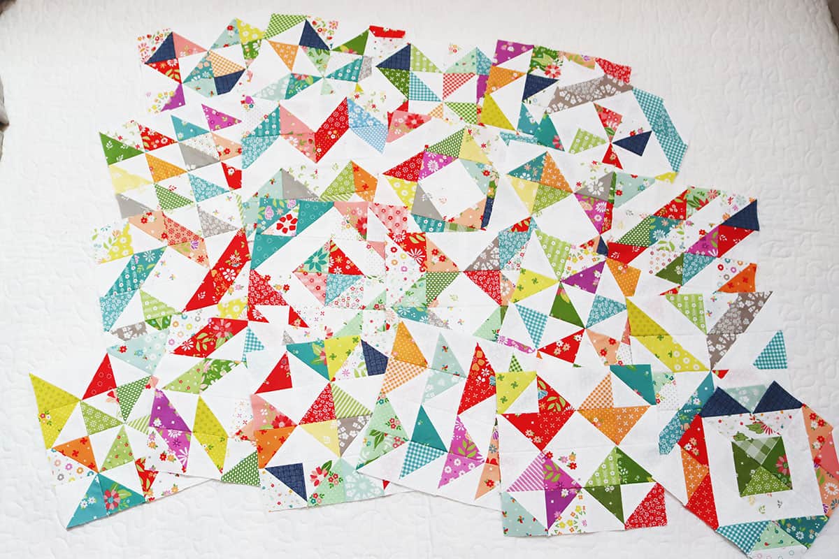 Scrappy half square triangle blocks in fabrics by Sherri & Chelsi