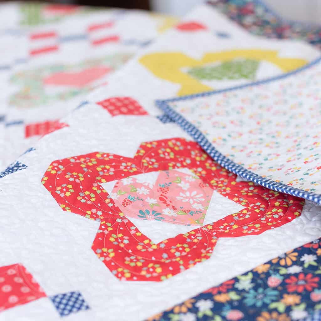 I Heart Flowers Layer Cake quilt by Sherri of A Quilting Life