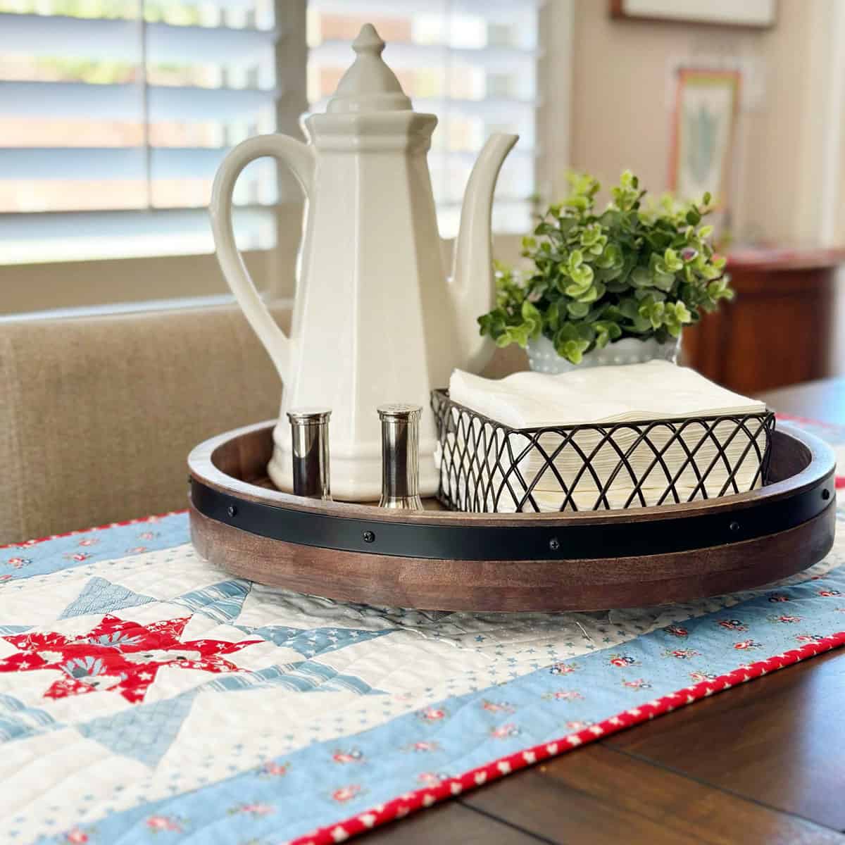 Stars in Summer Runner on table with pitcher, plant, napkins, and salt and pepper shakers.