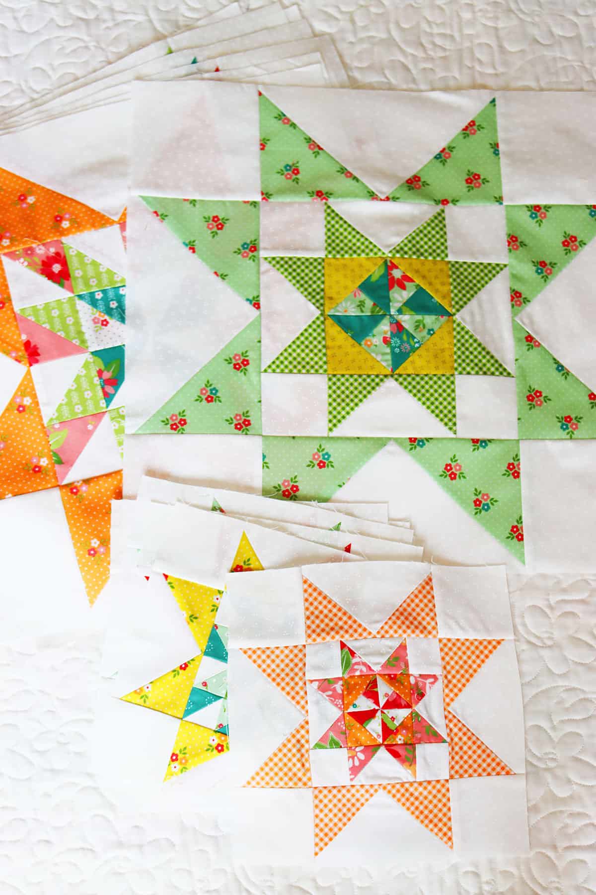 A Quilting Life 2024 Block of the Month blocks by Sherri from A Quilting Life in Strawberry Lemonade fabrics.