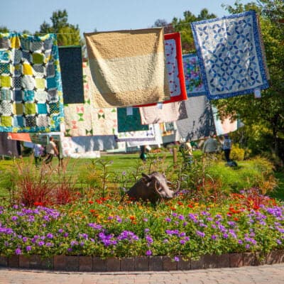 Garden of Quilts venue with quilts hanging outdoors.