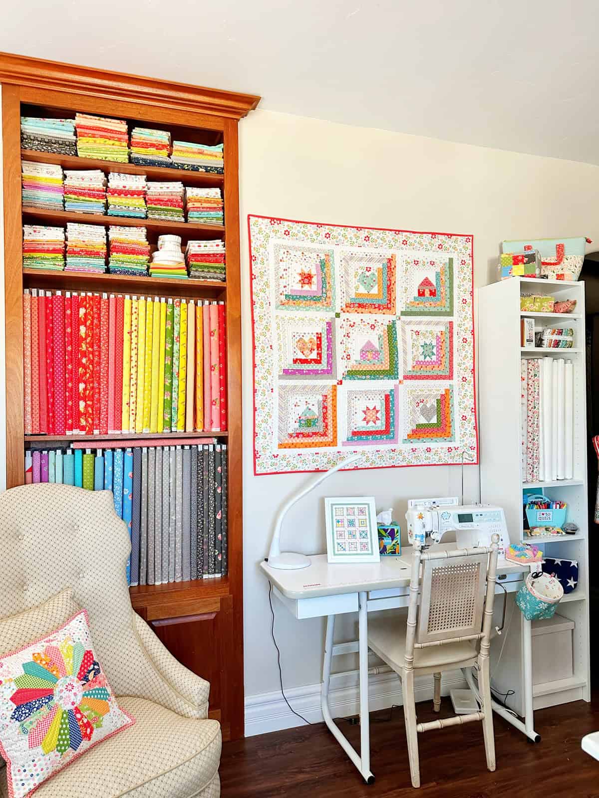 Sewing table and fabric shelves in the A Quilting Life sewing studio