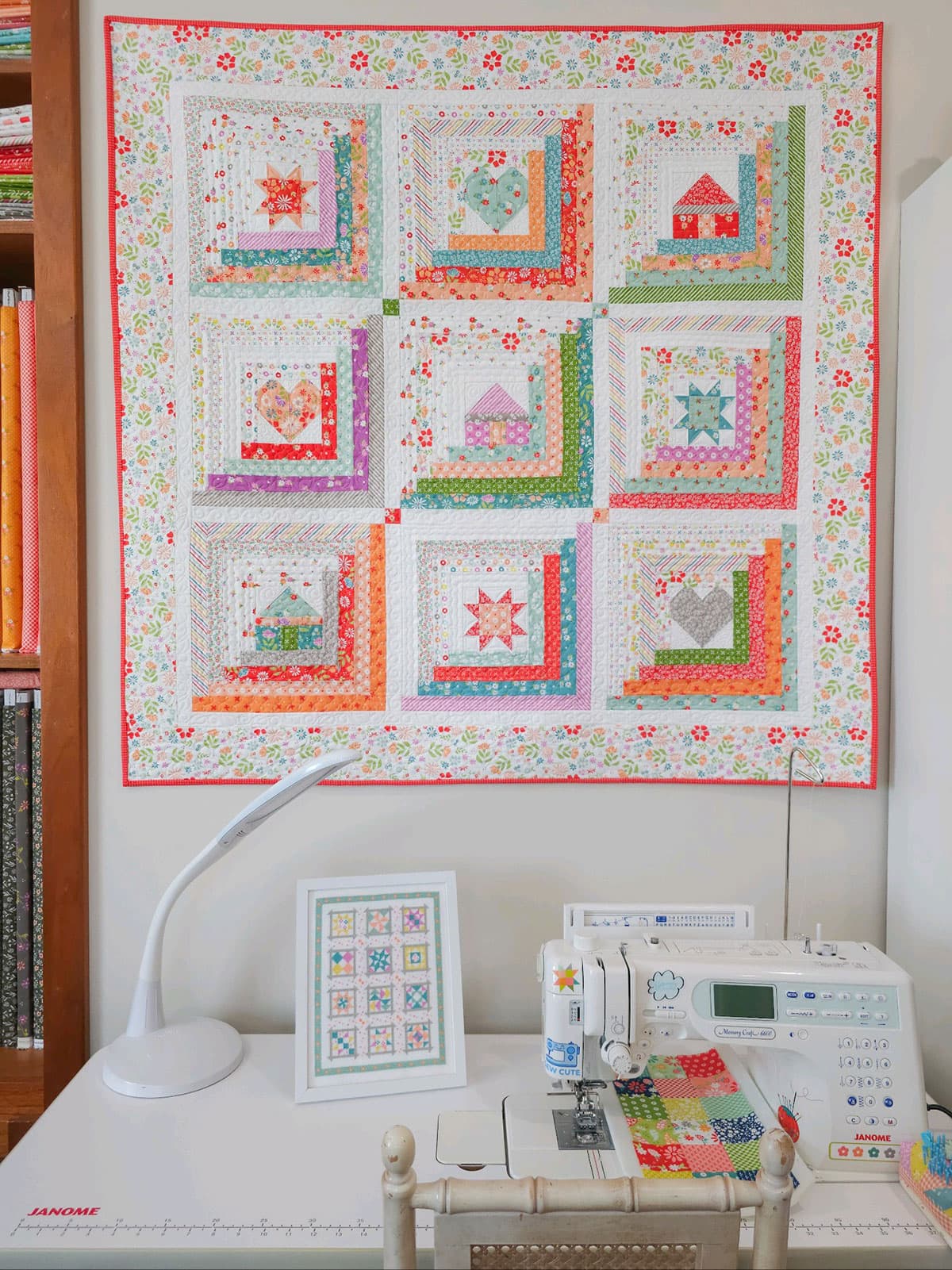 Log cabin wall quilt with stars, hearts, and houses by Sherri from A Quilting Life