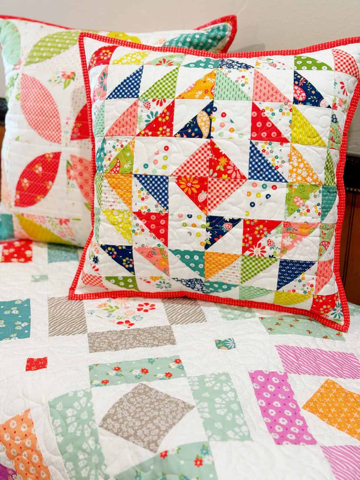 Half-Square Triangle Pillow in Raspberry Summer with Orange Peel Pillow in Strawberry Lemonade fabrics by Sherri & Chelsi for Moda