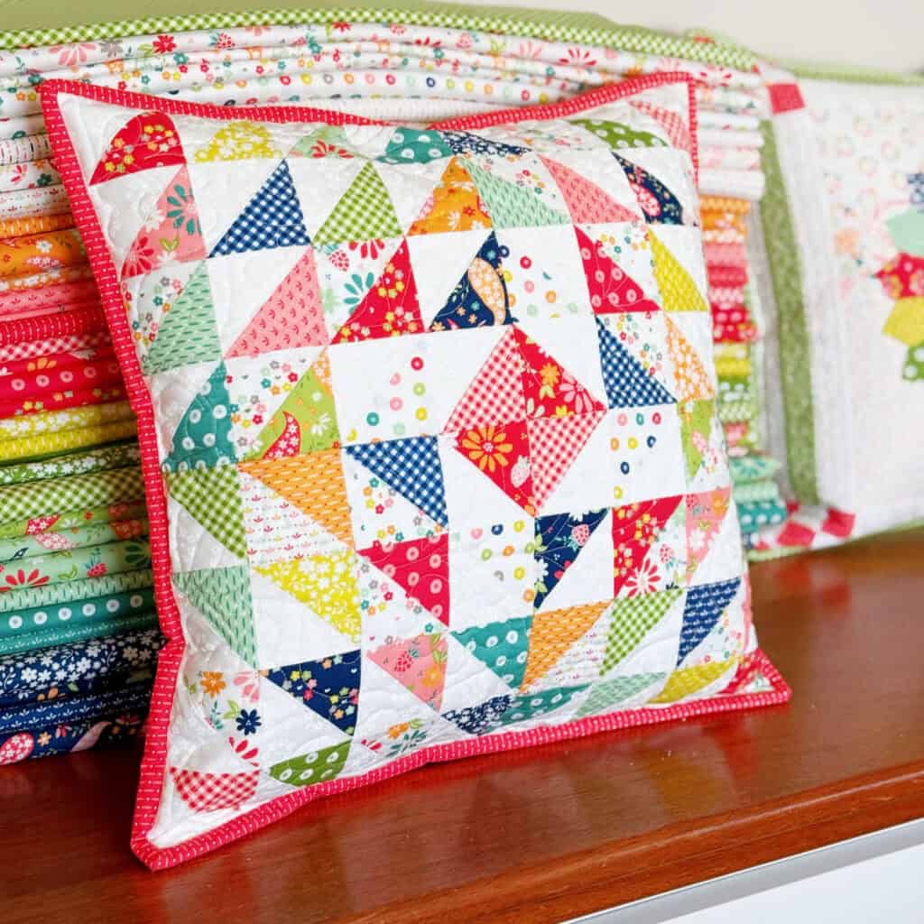 Half-Square Triangle Pillow in Raspberry Summer Fabrics by Sherri & Chelsi for Moda