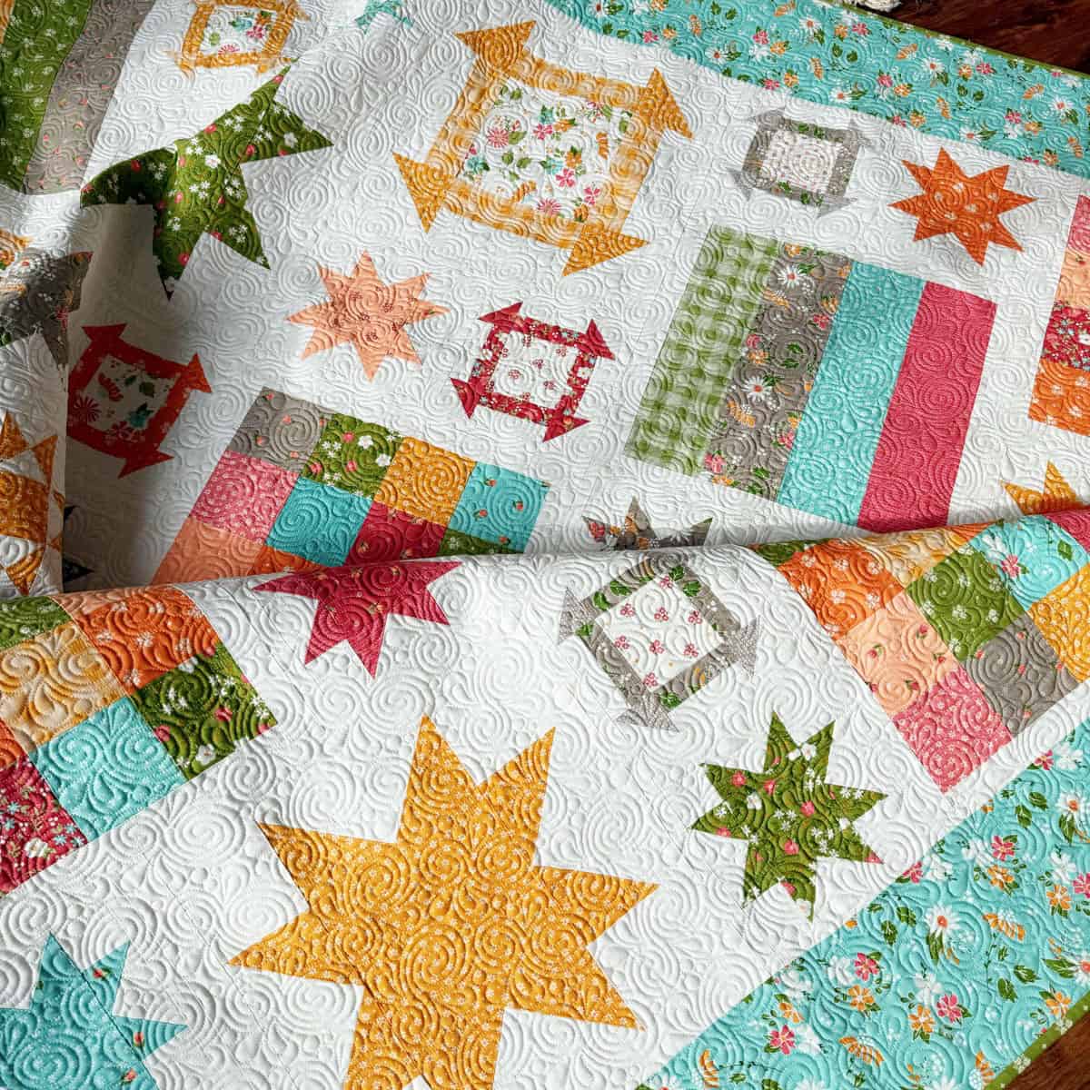 King-size quilt by Sherri McConnell of A Quilting Life using fabrics from Bountiful Blooms by Sherri & Chelsi for Moda fabrics