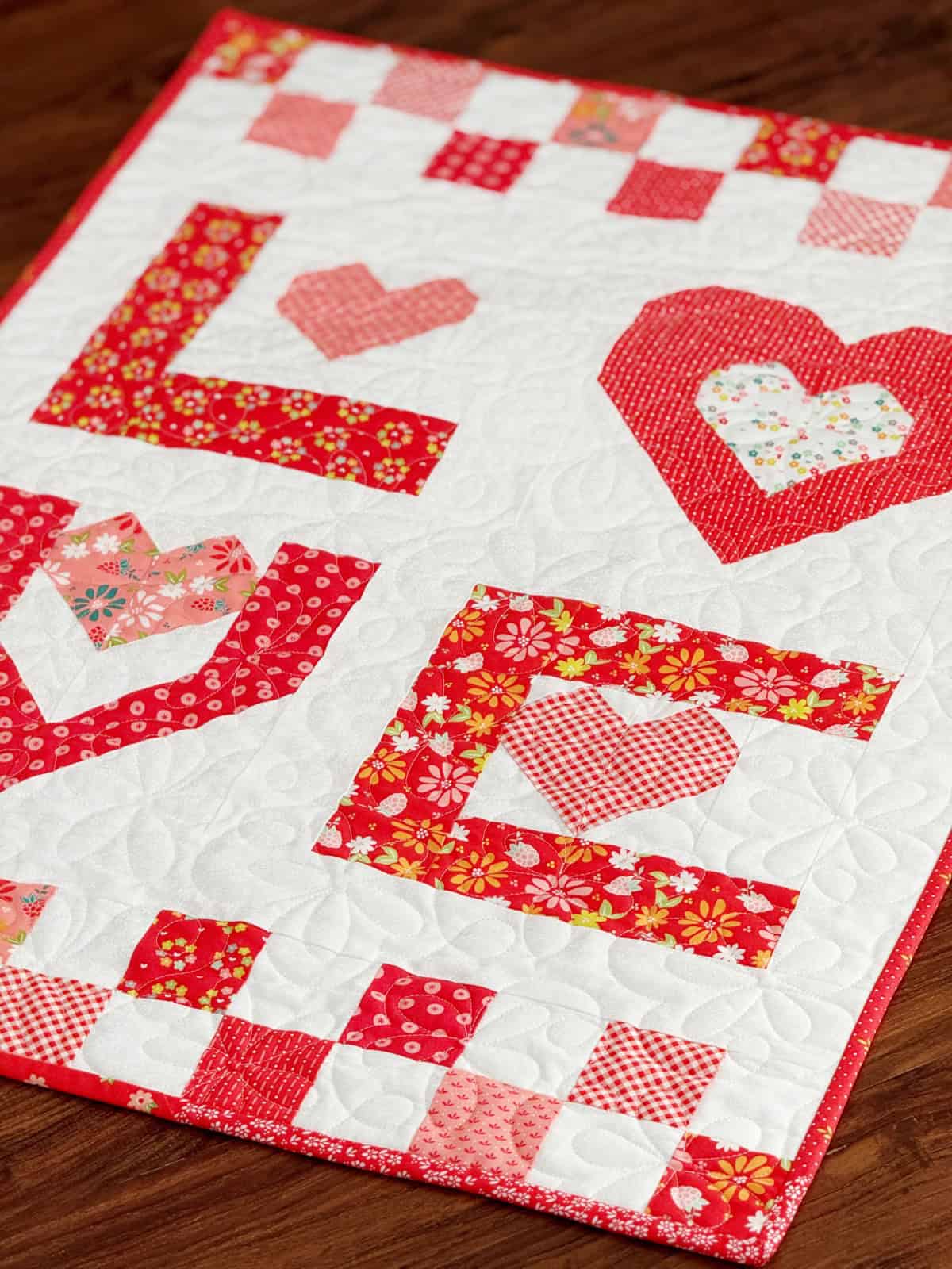 Love Wall hanging in Raspberry Summer Fabrics by Sherri & Chelsi