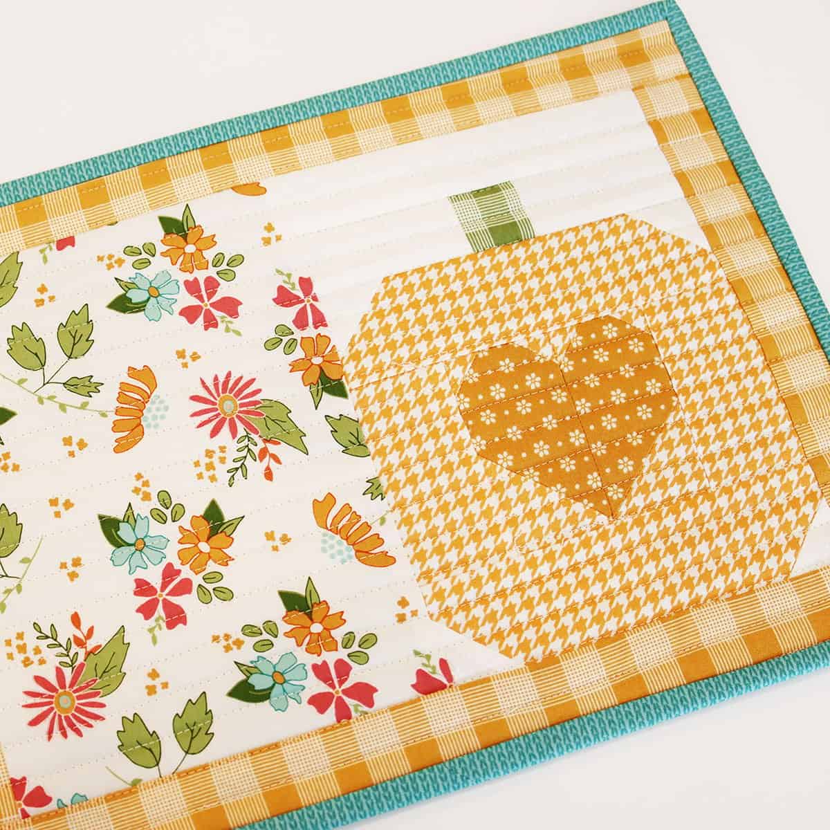 Pumpkin Table Mat by Sherri McConnell of A Quilting Life