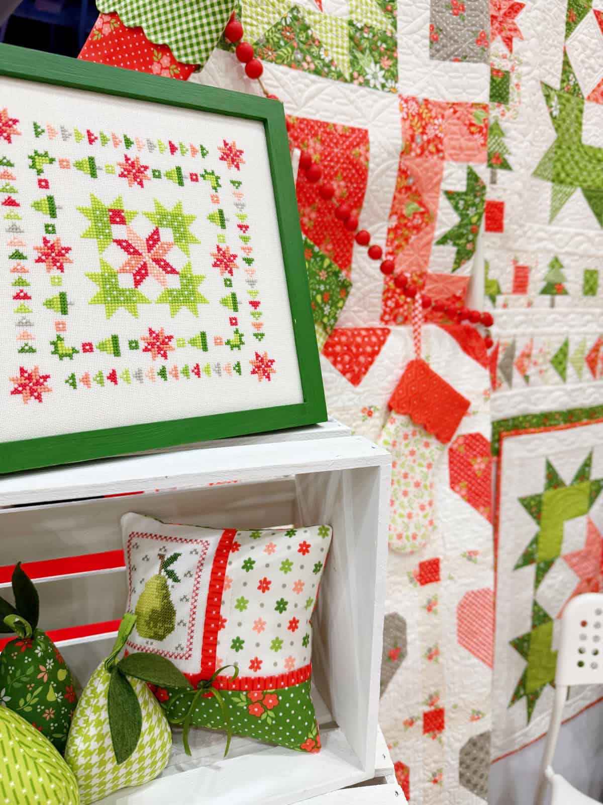 Quilts on display at International Quilt Market in Houston Texas October 2025 with Poinsettia & Pear fabrics