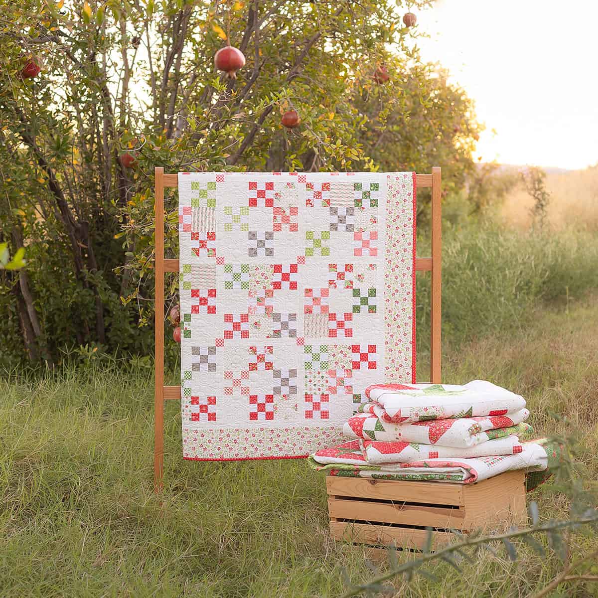 Homespun quilt and quilt stack in Poinsettia & Pear fabrics by Sherri & Chelsi for Moda Fabrics