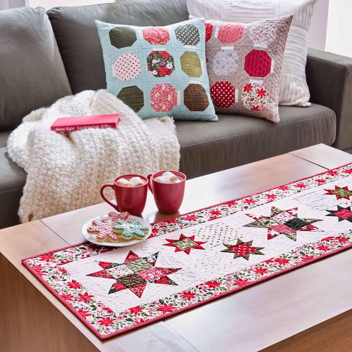 Christmas Pillows and Table Runner in Berry & Pine fabric by Lella Boutique for Moda Fabrics. Used with permission from American Patchwork & Quilting® magazine. ©2025 Meredith Operations Corporation. All rights reserved.