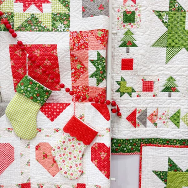 Whimsy Stars and Wreath & Pine quilts by Sherri from A Quilting Life with Christmas stockings