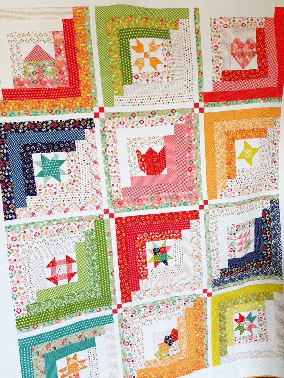 A Quilting Life 2025 BOM Quilt in Raspberry Summer Fabrics for Moda