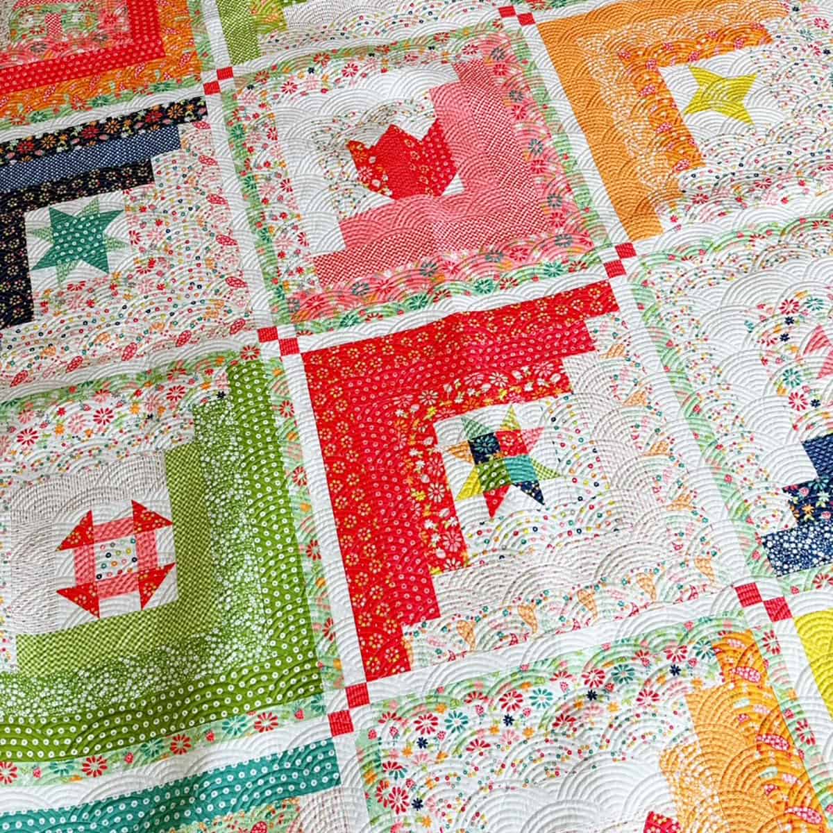 A Quilting Life 2025 BOM Quilt in Raspberry Summer Fabrics for Moda