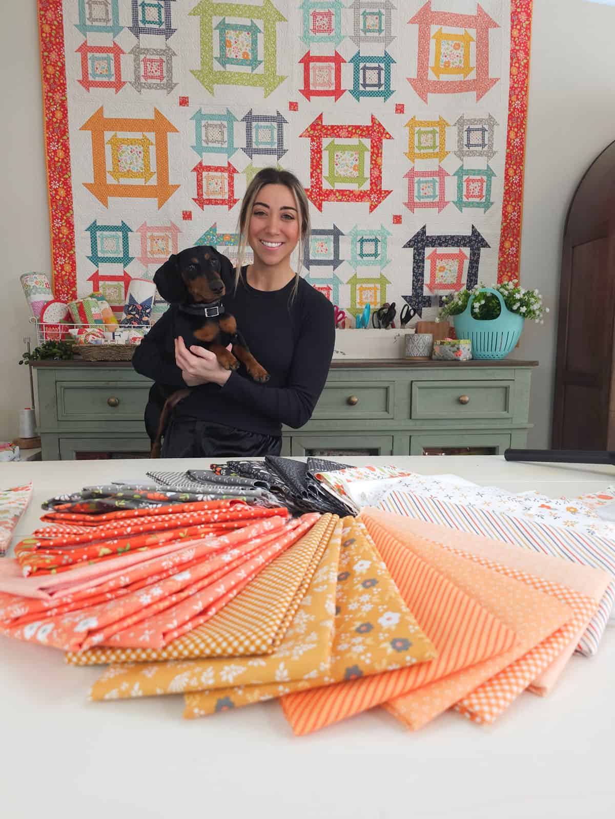 Chelsi Stratton and Moose in the A Quilting Life Studio