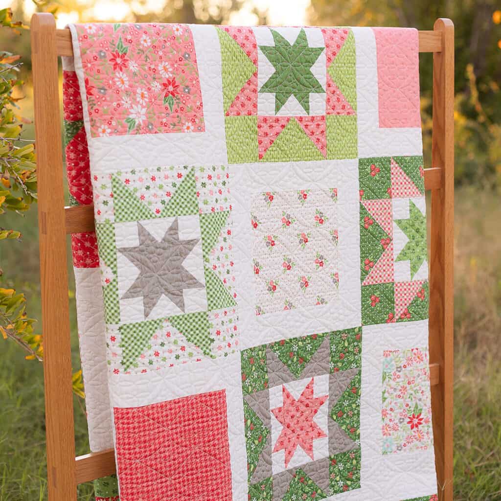 Whimsy Stars quilt in Poinsettia & Pear fabrics by Sherri McConnell of A Quilting Life