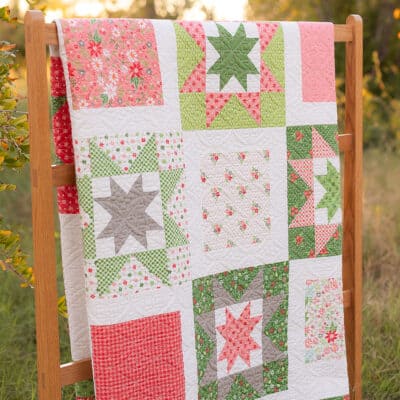 Whimsy Stars quilt in Poinsettia & Pear fabrics by Sherri McConnell of A Quilting Life