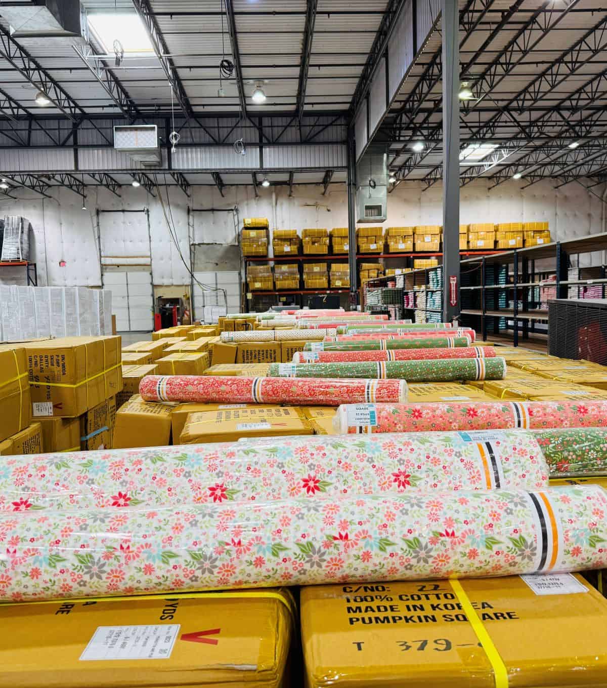 Poinsettia & Pear rolls of fabric in the Moda warehouse